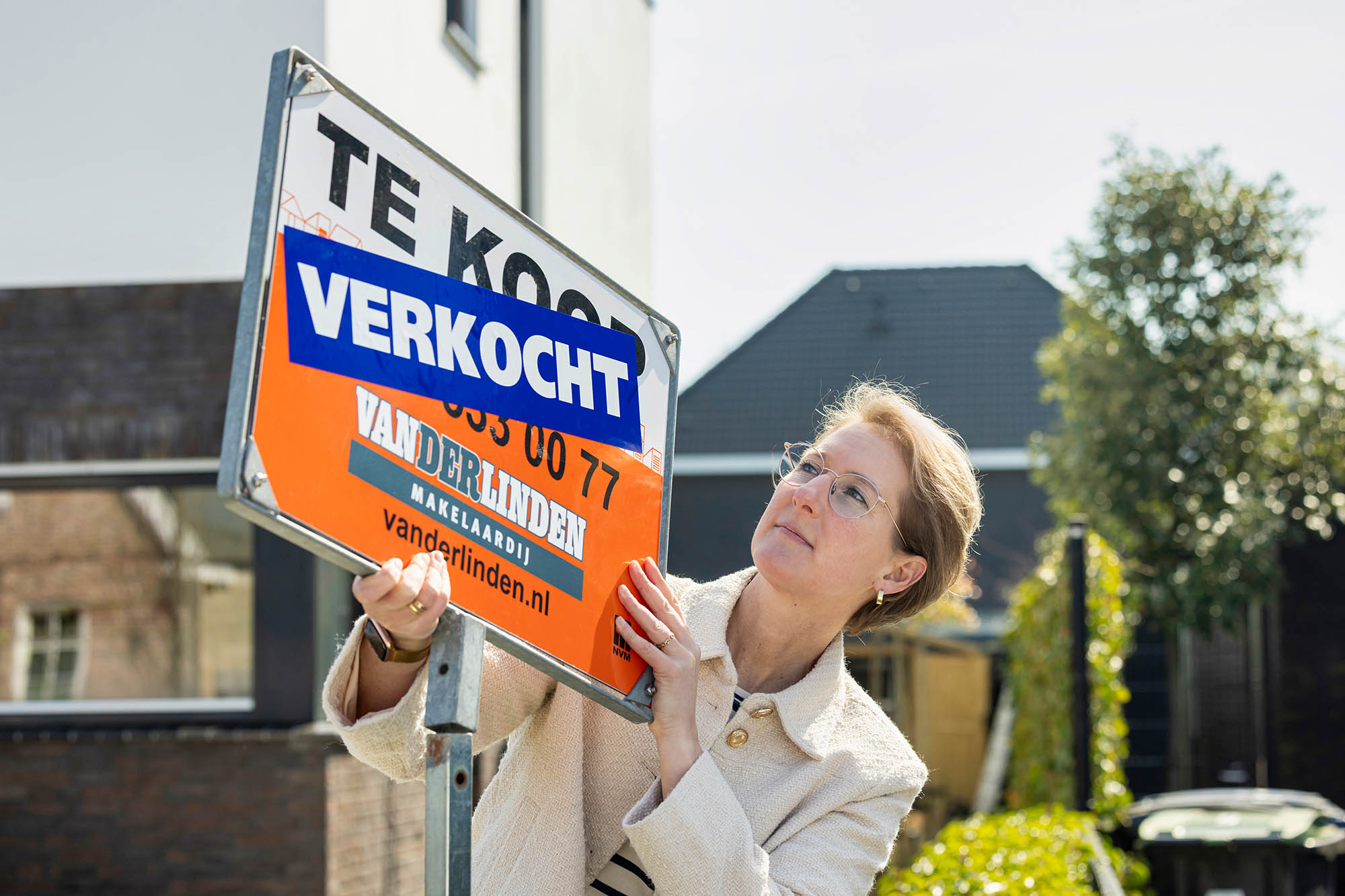 Real estate agent with sold sign